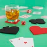 Close up of playing cards and coasters with drink