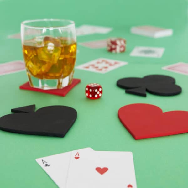 Close up of playing cards and coasters with drink