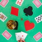 Playing cards and coasters with drink
