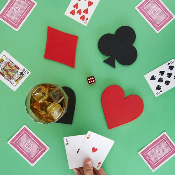 Playing cards and coasters with drink